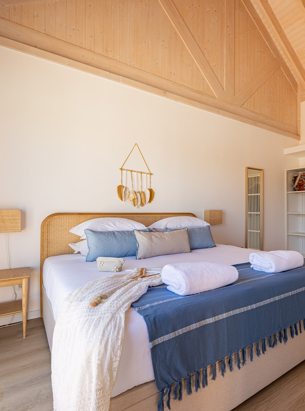 Die Premium Villa im Pestana Comporta Village Residences hat ein Schlafzimmer mit Doppelbett und mehreren blauen Kissen