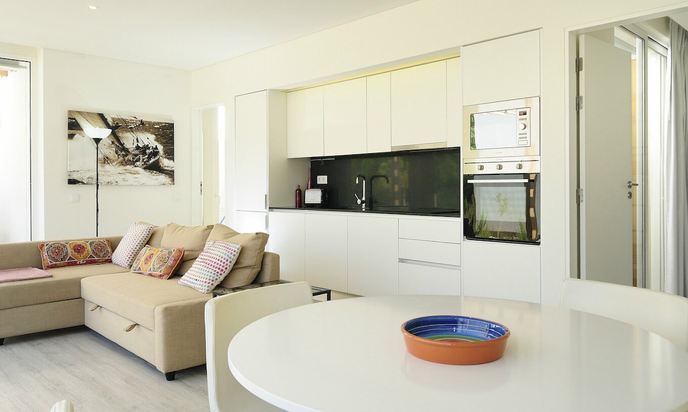 Die Green Villa mit privatem Pool T3 im Pestana Tróia Eco Resort hat einen Wohnbereich mit Küche, Sofa und Esstisch