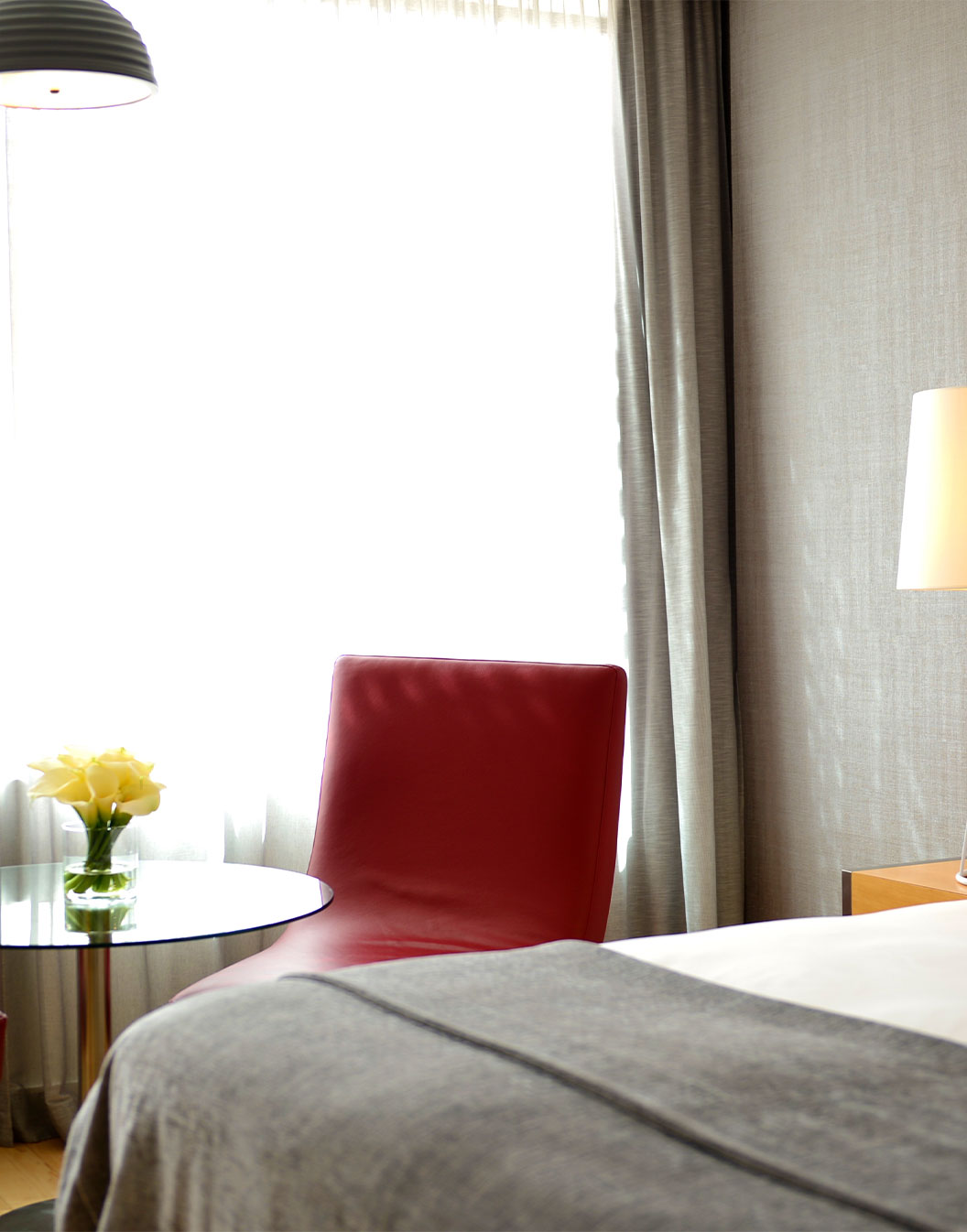 Das Superior Zimmer mit Balkon im Pestana Cidadela Cascais hat ein Doppelbett und einen kleinen Tisch mit rotem Stuhl