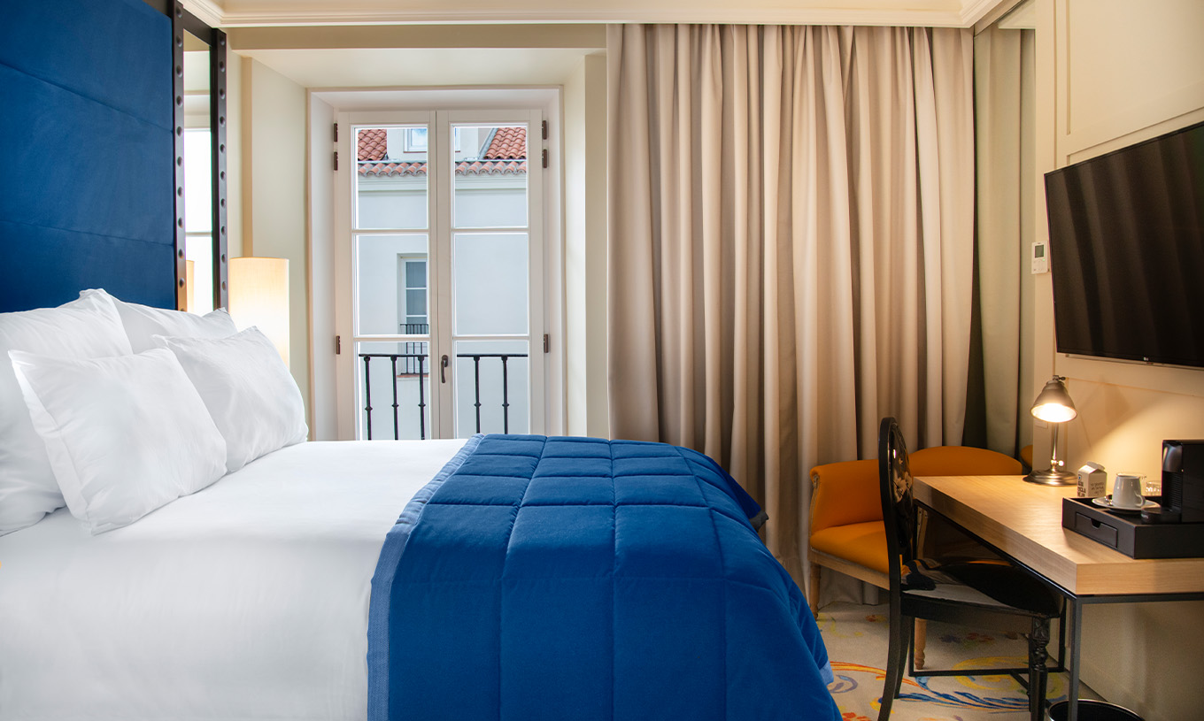 Das Klassische Zimmer im Pestana Plaza Mayor Madrid hat ein Doppelbett, Fernseher, Schreibtisch und ein Fenster