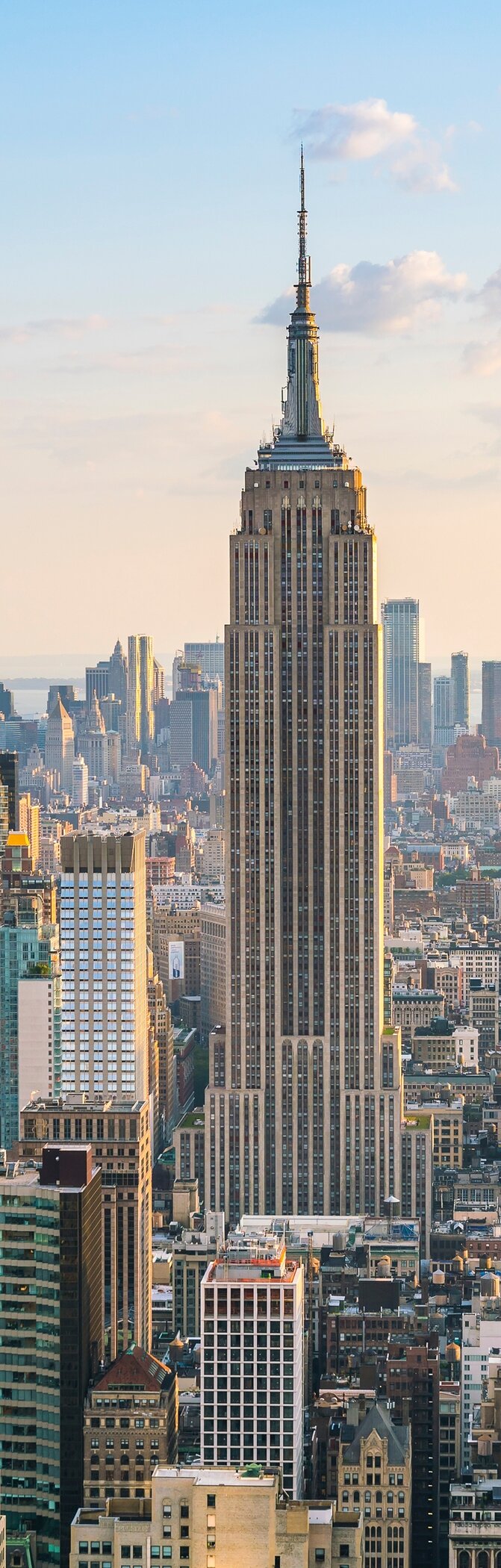 Skyline von New York mit dem Empire State Building im Vordergrund, umgeben von Wolkenkratzern in der Innenstadt von Manhattan