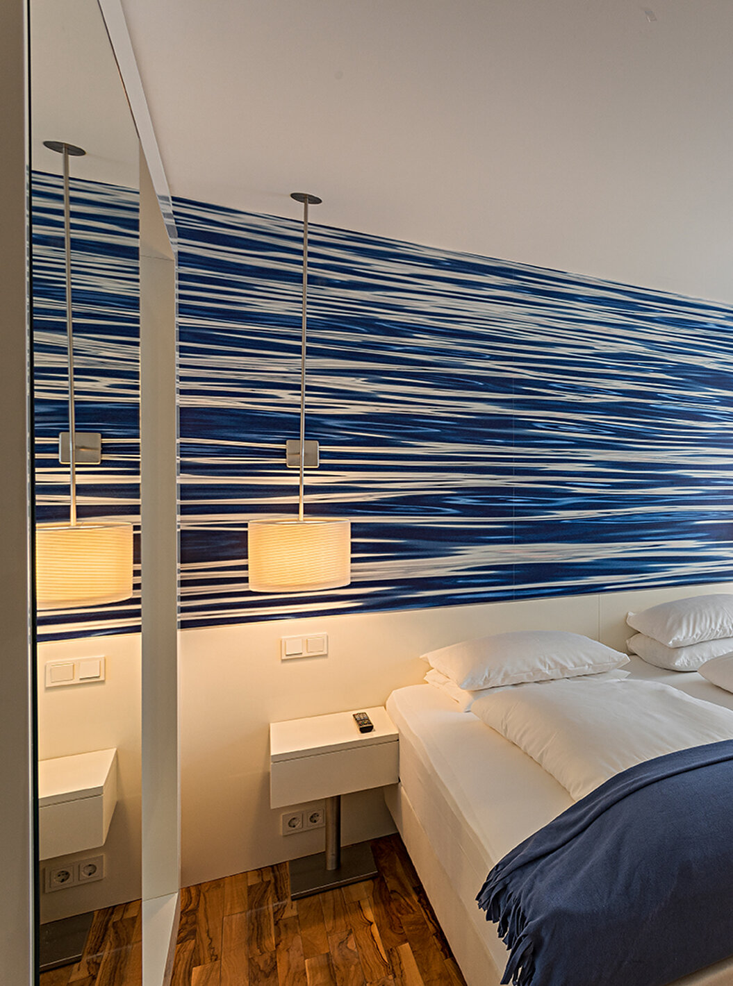 Family Deluxe with double or twin beds and blue-toned wallpaper.