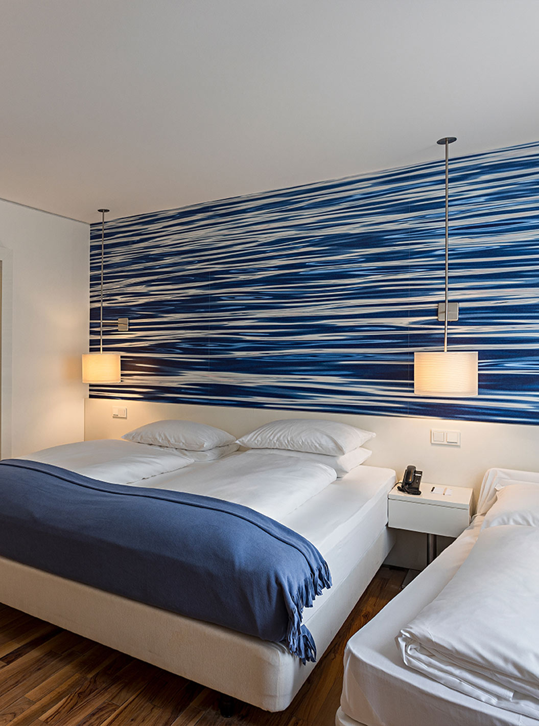 Family Deluxe is a spacious room with blue-toned decor