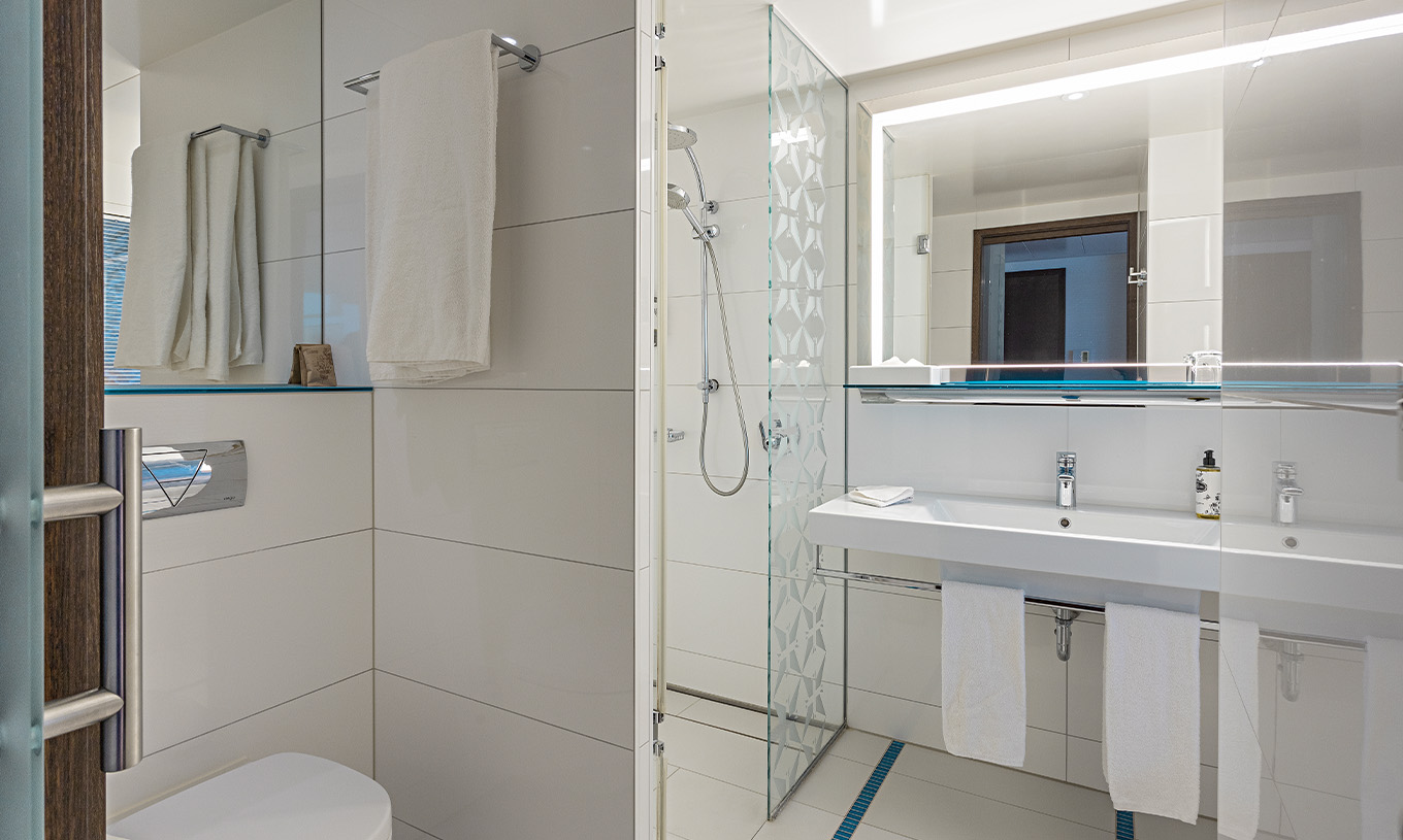 Premium Room with Balcony and View at Pestana Berlin Tiergarten has a bathroom with shower, sink and mirror