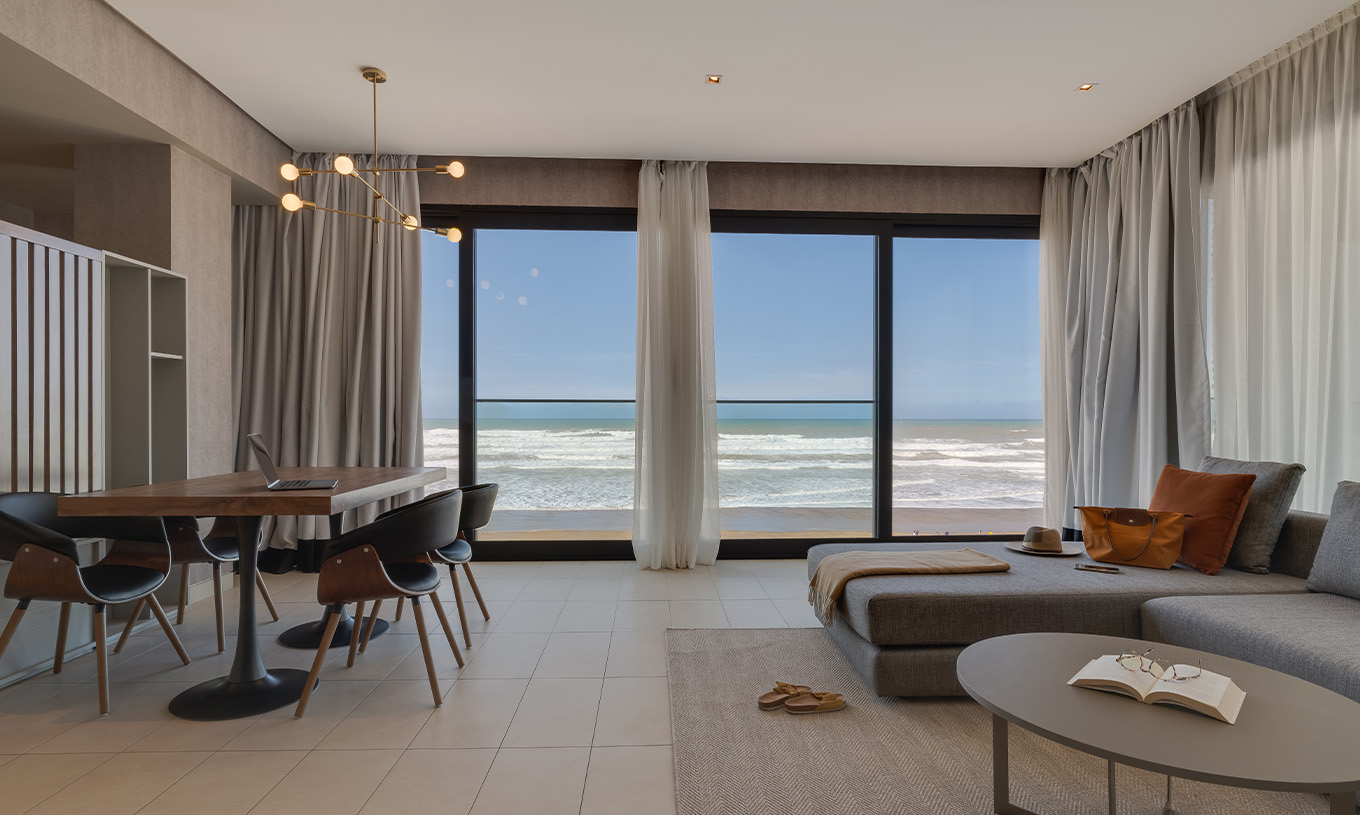 The Family Corniche Suite at Pestana Casablanca has a living room with a sofa and spectacular beach views