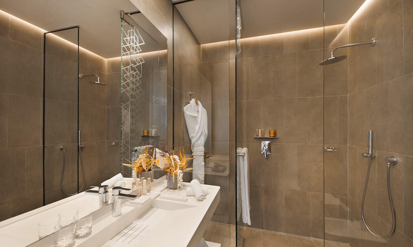 The CR7 Room at Pestana CR7 Marrakech has a bathroom with a walk-in shower, sink with mirror, and various amenities