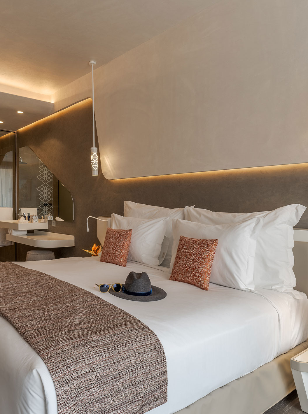 Pestana CR7 Marrakech CR7 Superior room featuring a modern bedroom with soft lighting, open wardrobe and vanity