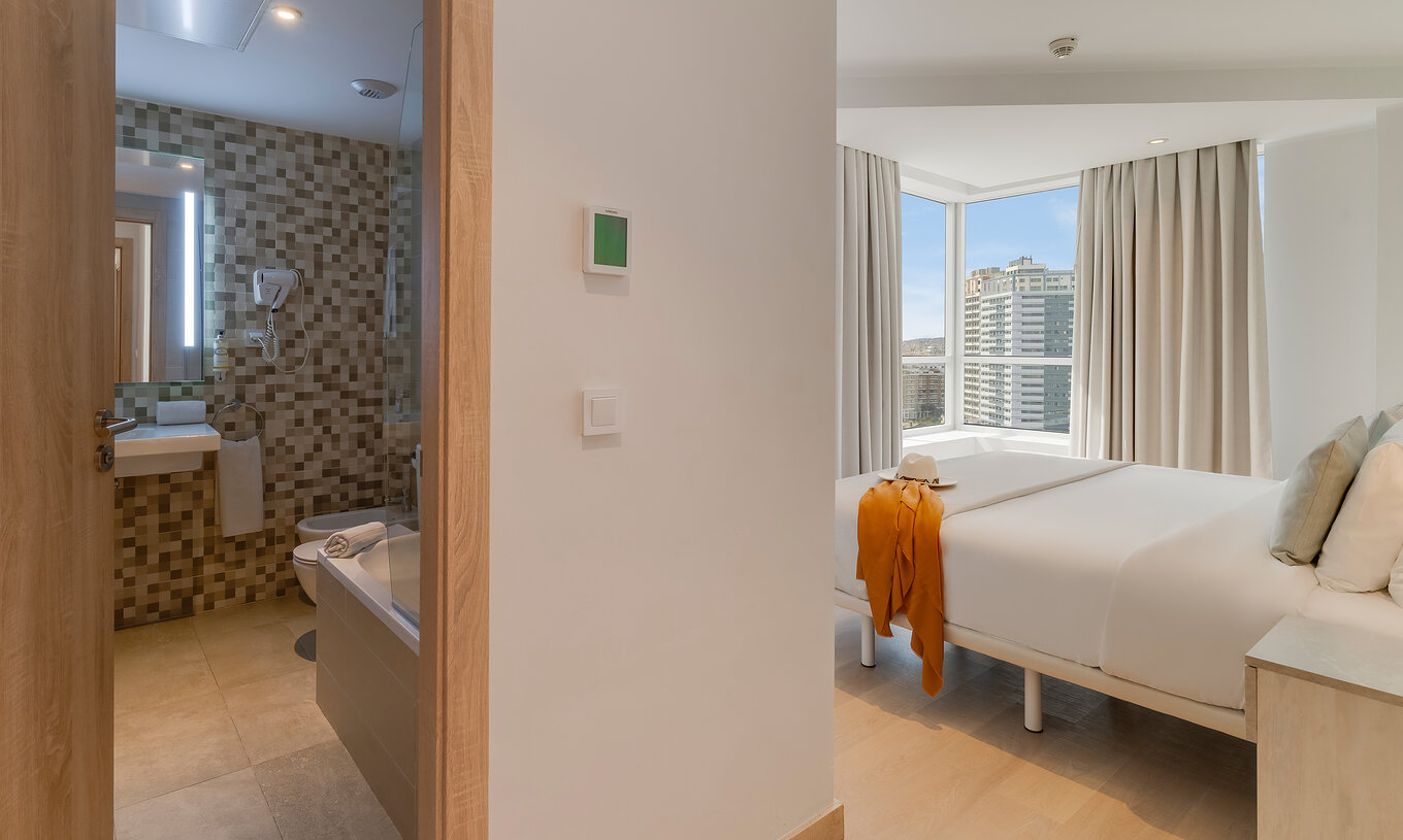 The Family Suite of Pestana Tanger City Center features a bathroom, a double bed, and a large window