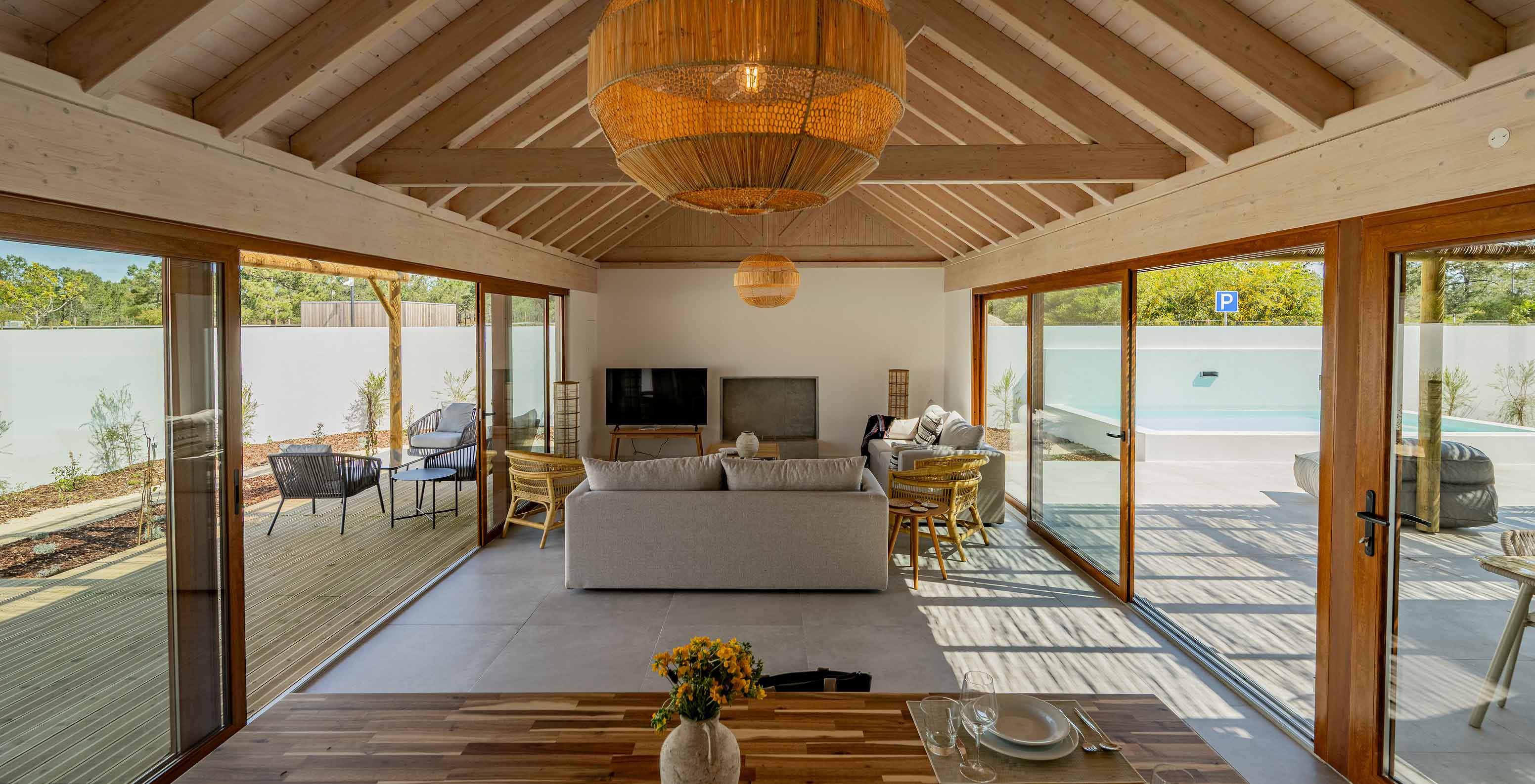 The Premium Green Villa at Pestana Comporta Village Residences has a modern living room with large windows and a table