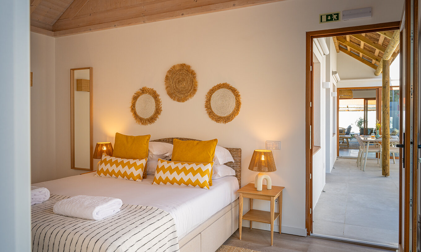The Superior Green Villa at Pestana Comporta Village Residences has a bedroom with a double bed and yellow pillows