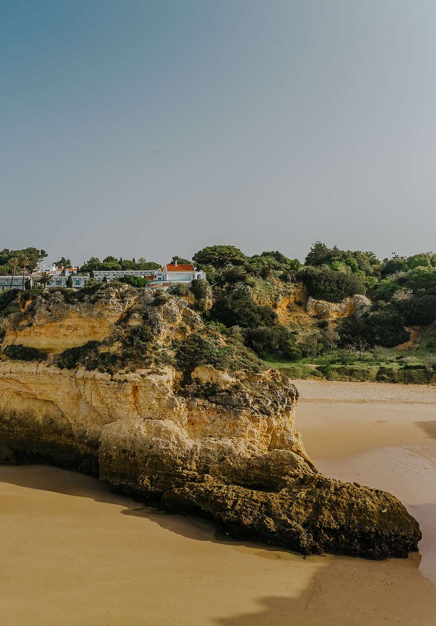 Rocky Algarve beach near Pestana Dom João II, Hotel 4 Estrelas no Algarve with golden cliffs and calm sand