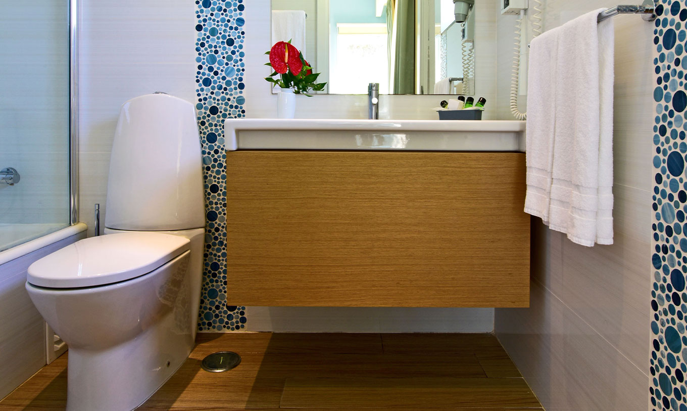 The Standard 2-Bedroom Garden View Villa at Pestana Alvor Beach Villas has a bathroom with a sink, mirror, and toilet