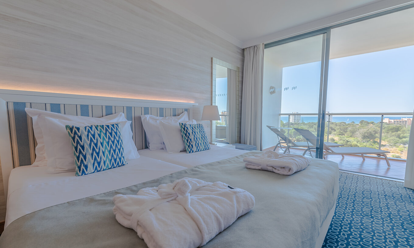 The T1 - with 1 Superior Bedroom at Pestana Alvor Park has two beds with a headboard and a balcony with sun loungers
