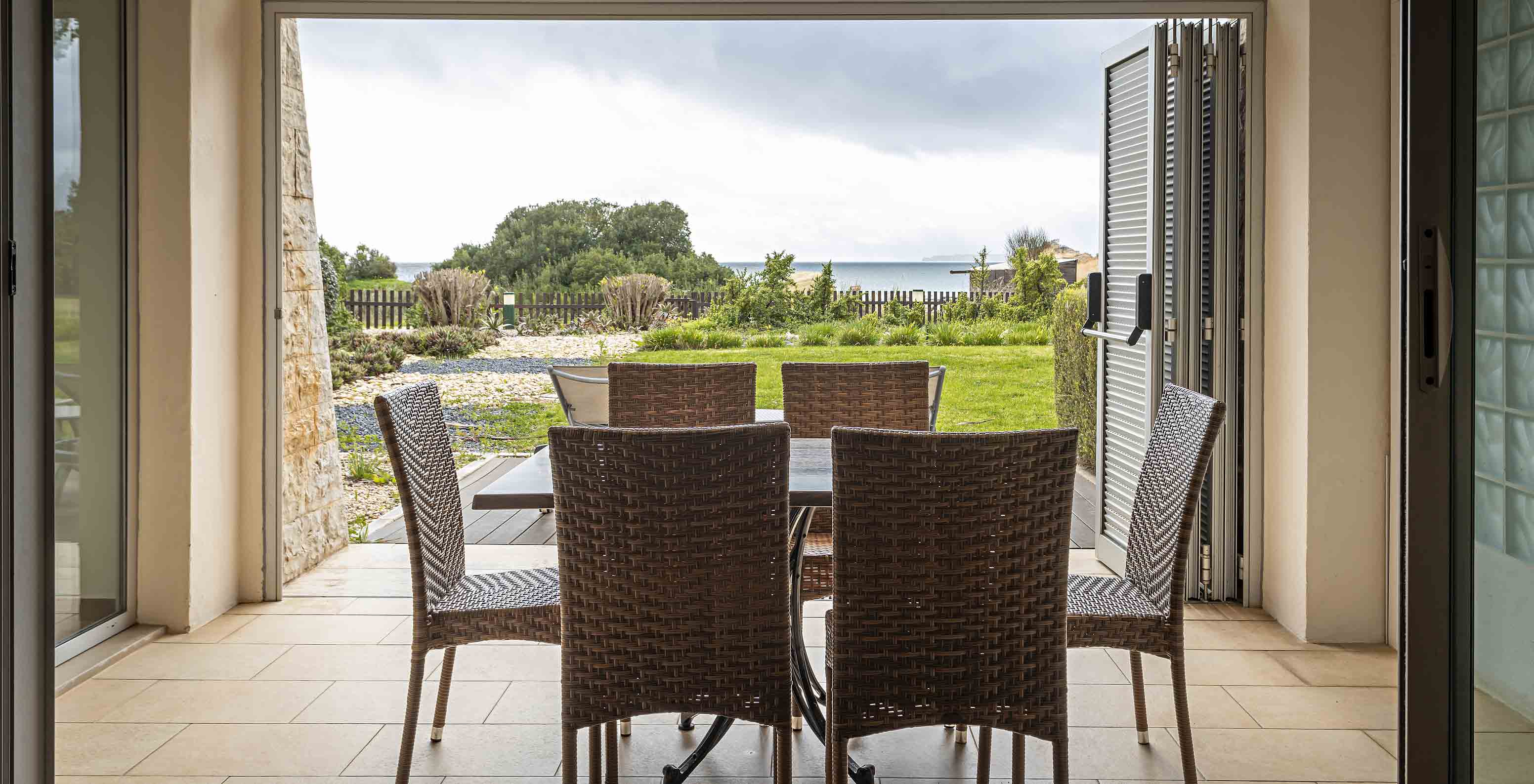 The Cliff Suite T2 at Pestana Alvor Praia has a porch with a table and chairs, and a garden with a view of the beach