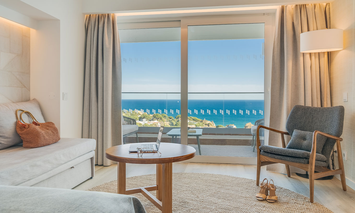 The Classic Sea View Room at Pestana Blue Alvor Beach has a balcony with a small table, two chairs, and a sea view