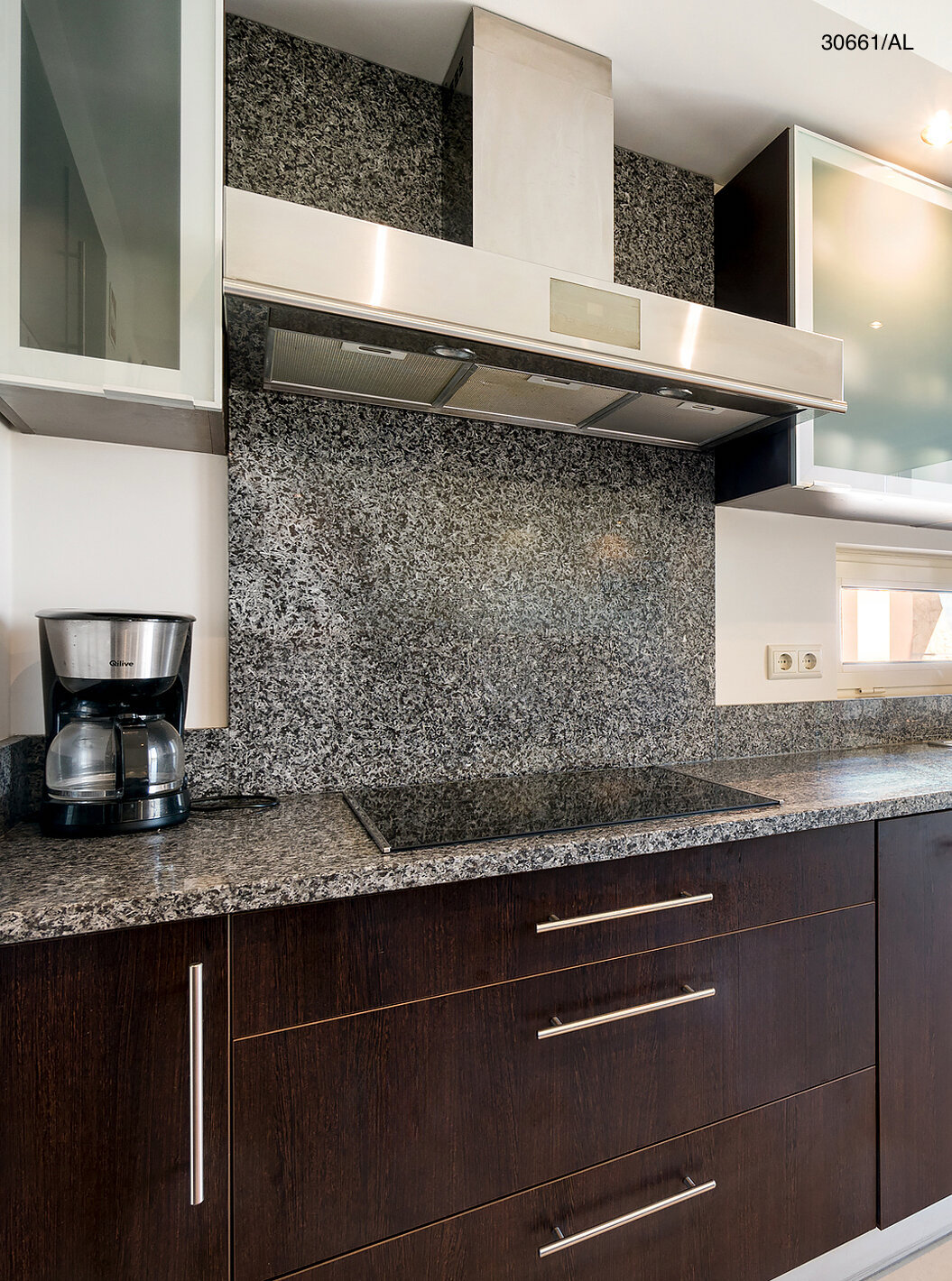 The Pestana Carvoeiro Golf T1 Superior Apartment has a kitchen with dark wood cabinets and a granite countertop