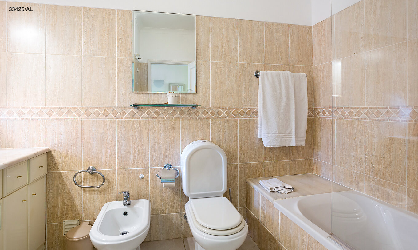 The Pestana Carvoeiro Golf T2 Standard Apartment has a bathroom with a bathtub, toilet, and bidet