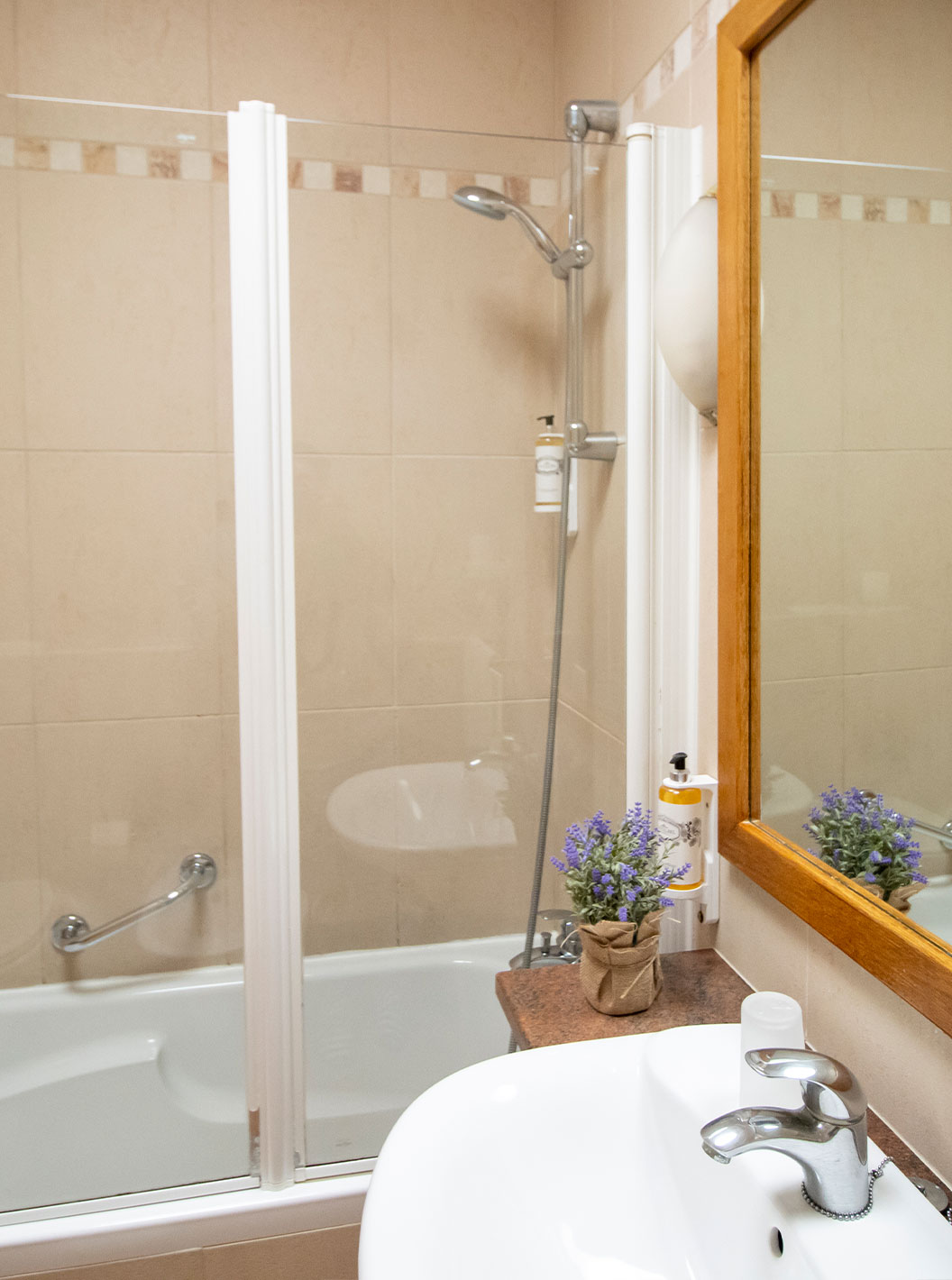 Standard One Bedroom Apartment at Pestana Palm Gardens featuring a beige bathroom with bath and mirror
