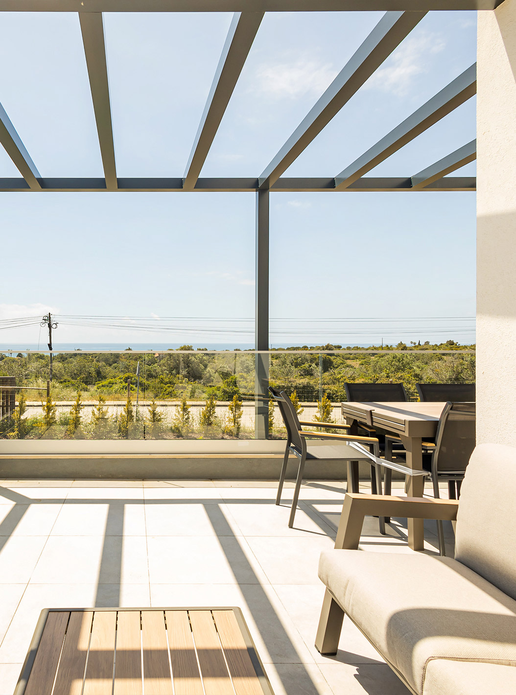 The Ground Floor 1 Bedroom Apartment at Pestana Valley Nature Village has a terrace with sofas and a dining table