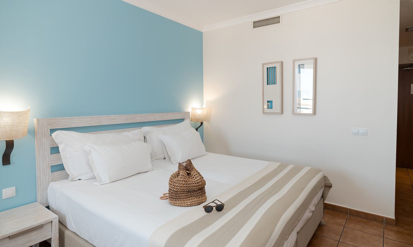 The Deluxe Side Sea View at Pestana Viking has two beds, bedside tables and two pictures on the wall