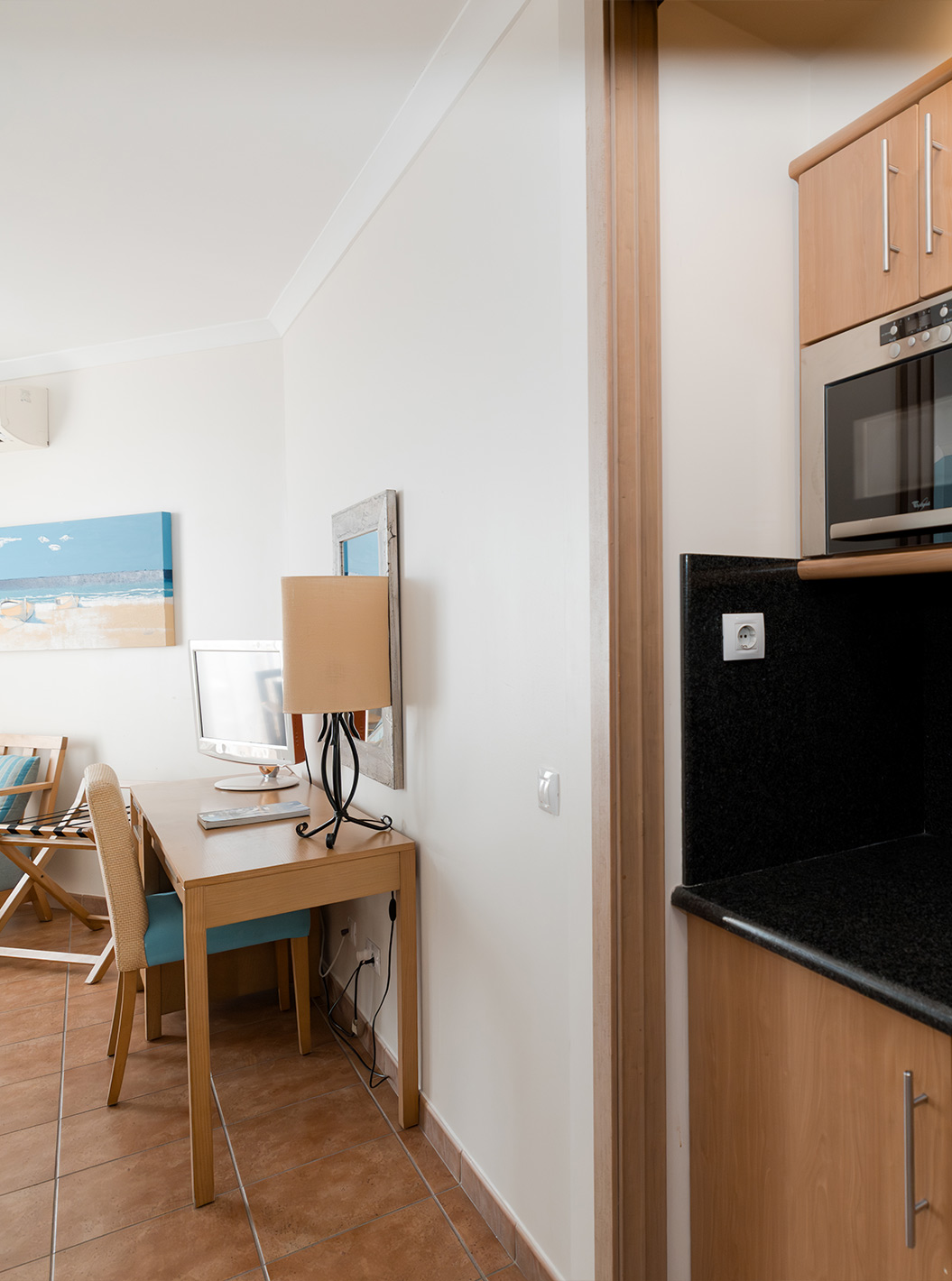 The Deluxe Sea View at Pestana Viking has a desk and a small kitchen with microwave and cabinets