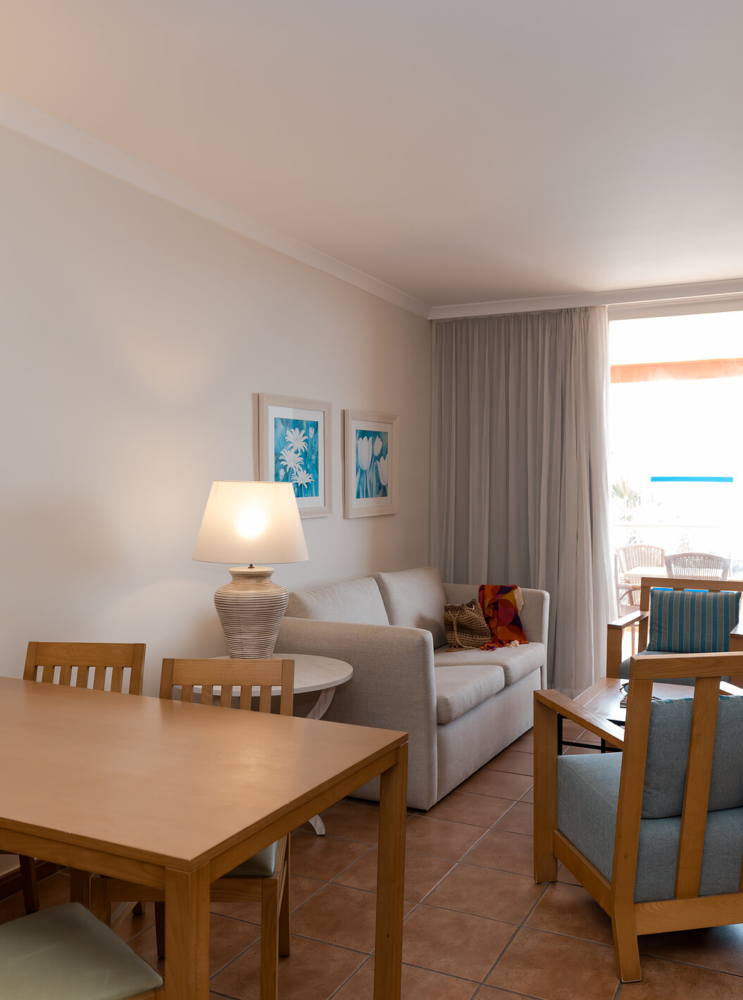 The T2 Suite at Pestana Viking has a living room with sofa, two armchairs and window with balcony access
