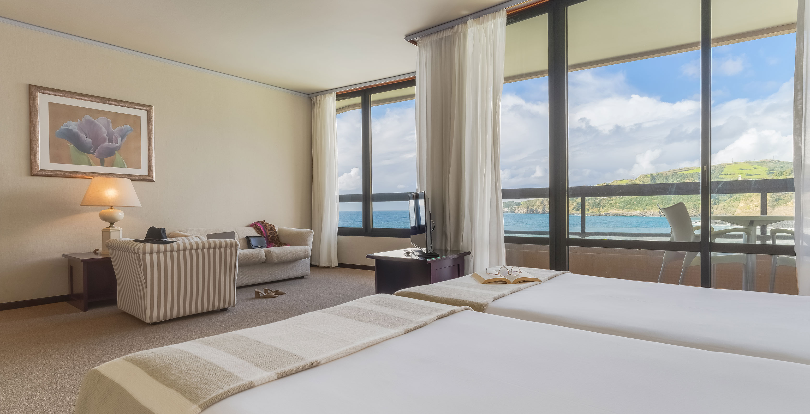 Junior Sea View Suite at Pestana Bahia Praia has a beautiful view of green landscapes and the sea, with access to the balcony