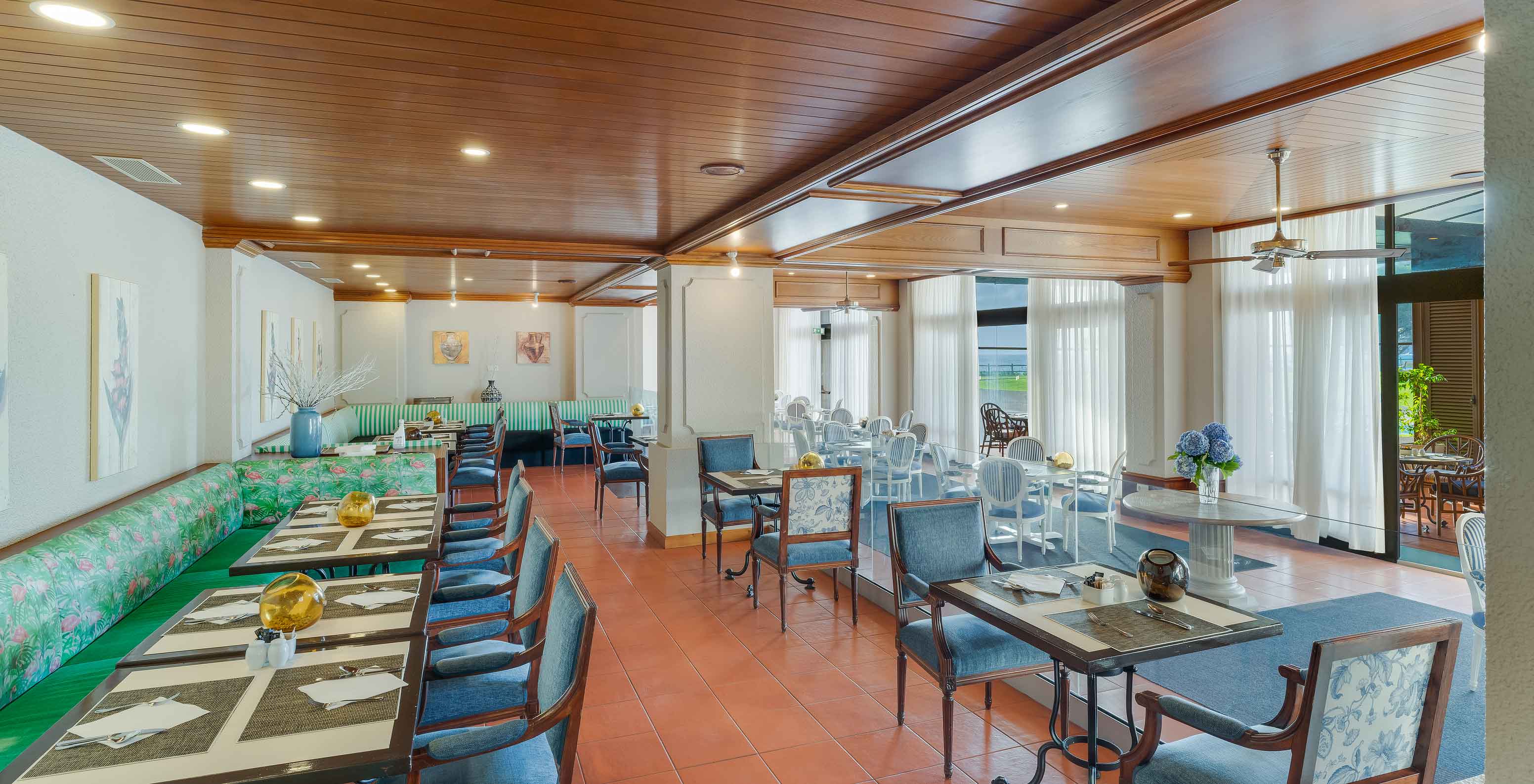 Interior of Lugar da Praia restaurant at Pestana Bahia Praia with set tables, chairs, and modern decor