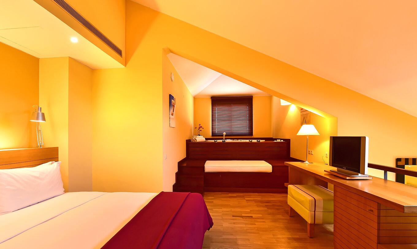 The Mezzanine Jacuzzi Suite of Pestana Sintra Golf has a double bed, jacuzzi in the room and a television in front of the bed