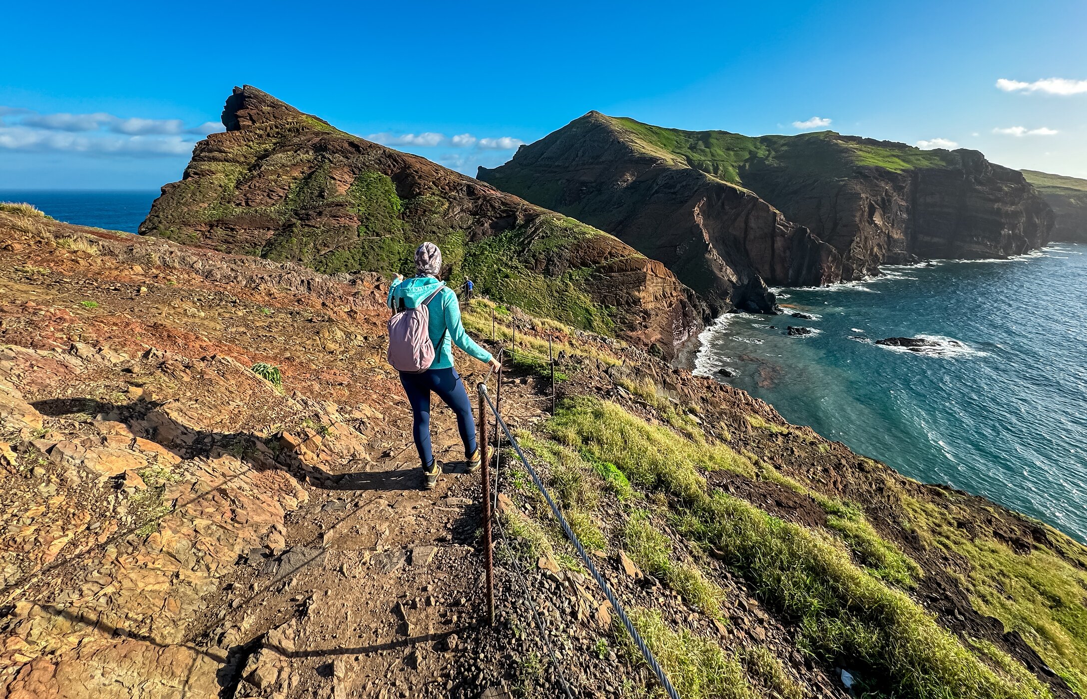 Lady hiking in Funchal, with a view of the mountain and the Atlantic Ocean