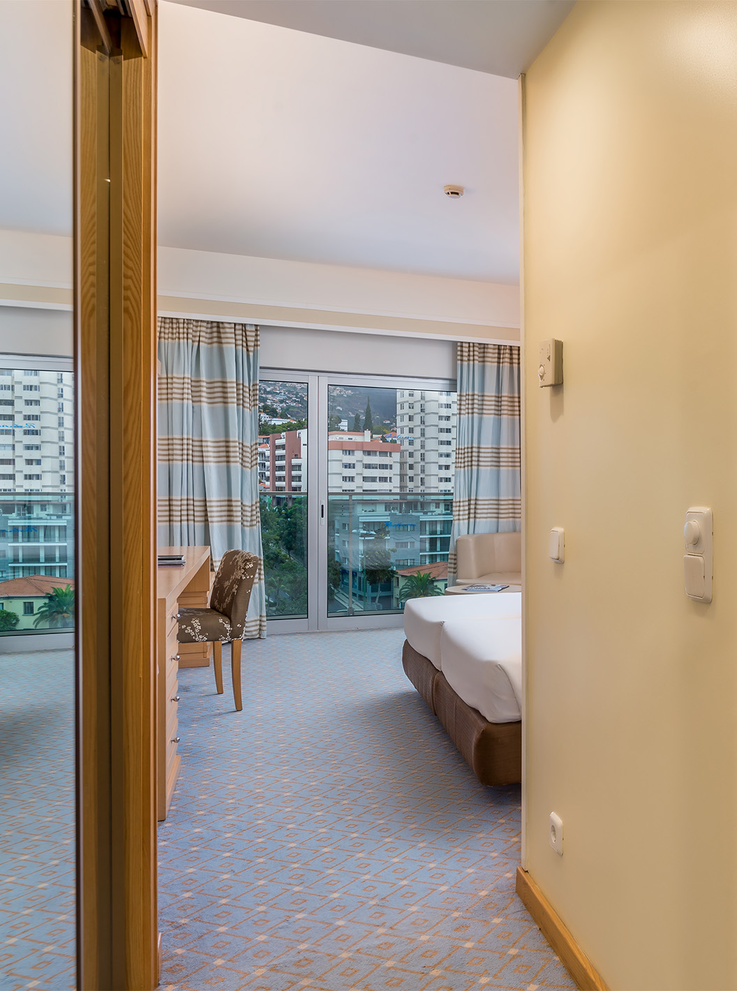 The Classic Double Room with City View at Pestana Carlton Madeira has a bathroom, large window, and a double bed