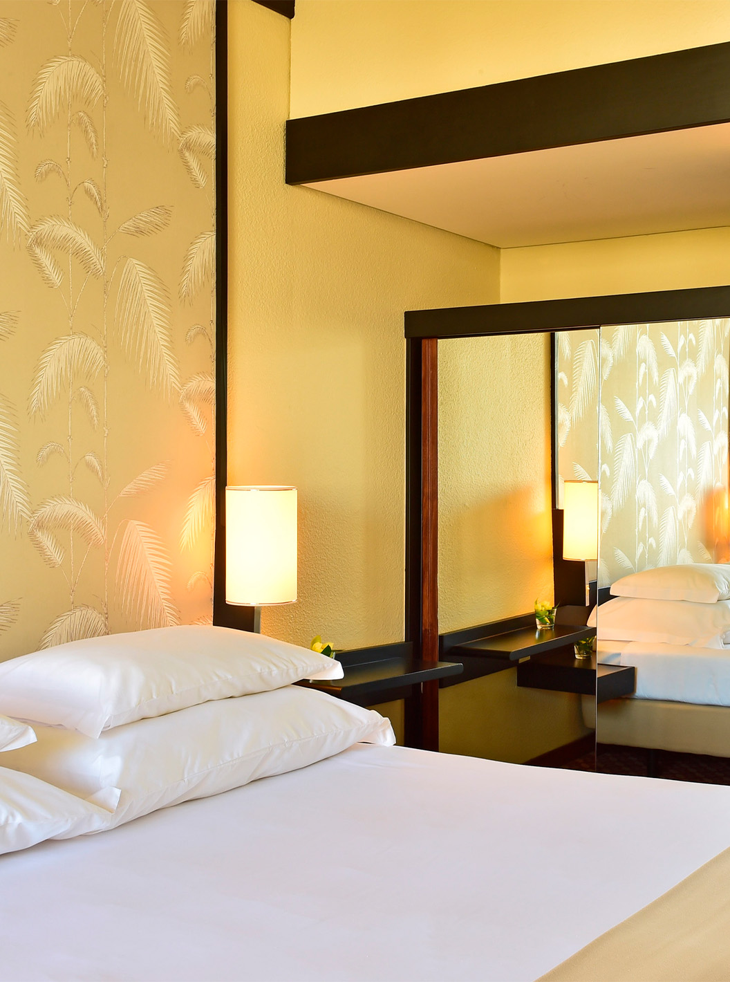 The Classic Land View room at Pestana Casino Park has a mirrored wardrobe next to the double bed