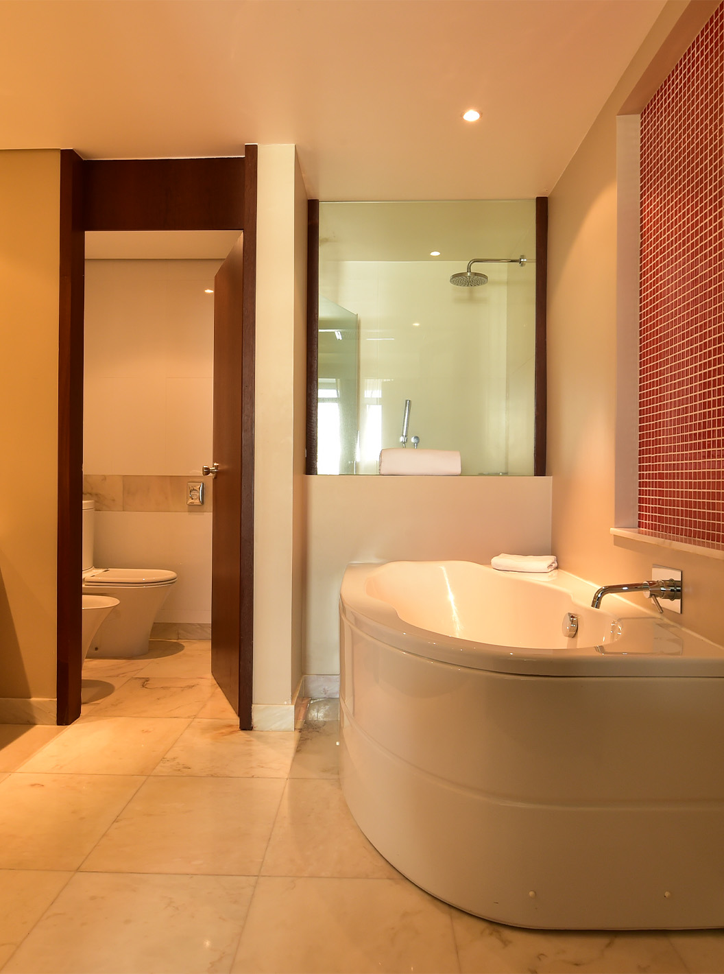 The Family Room at Pestana Casino Park has a bathroom with a bathtub and shower, toilet, and sink