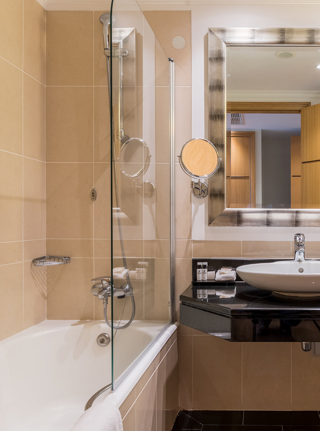 The Family Room at Pestana Grand has a bathroom with sink, bathtub with shower and towel