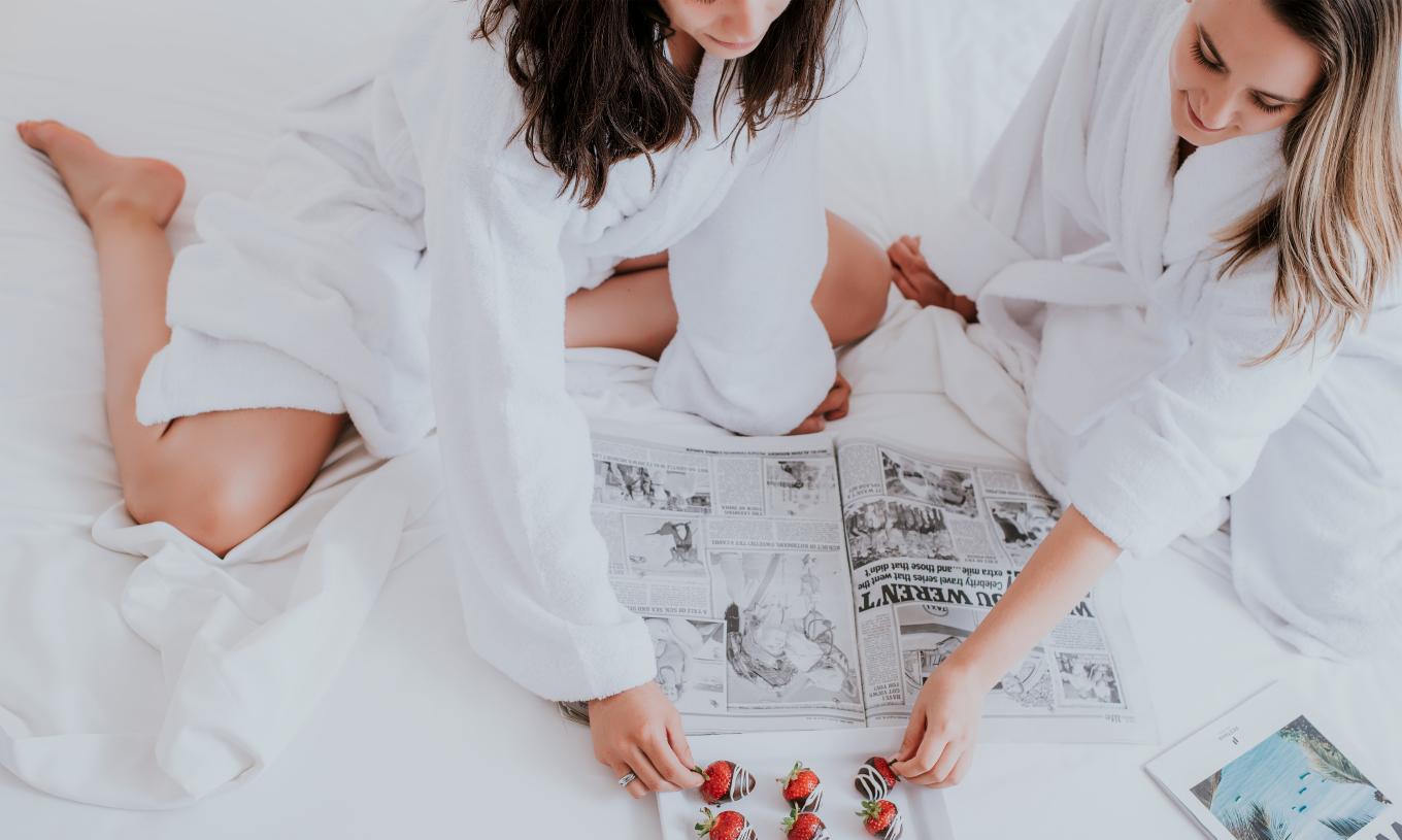 The T0 Studio at Pestana Madeira Beach Club has bathrobes available and a bed with newspapers and strawberries with chocolate