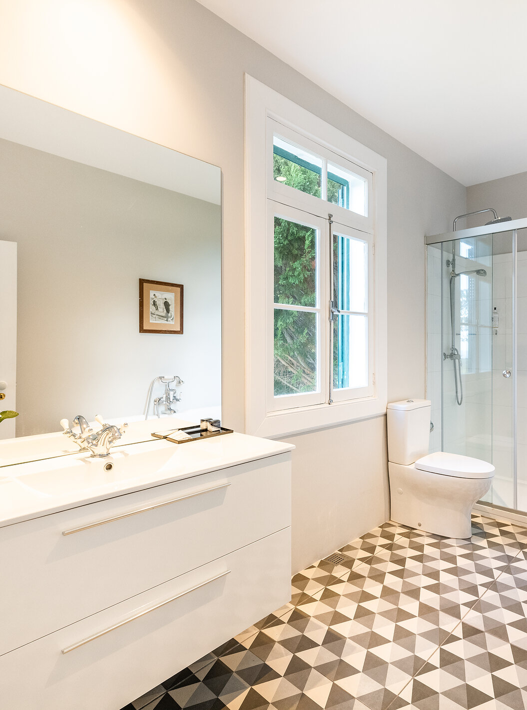 The Manor House - 1 of Pestana Quinta do Arco has a bathroom with bathtub and shower, sink with large mirror, and window