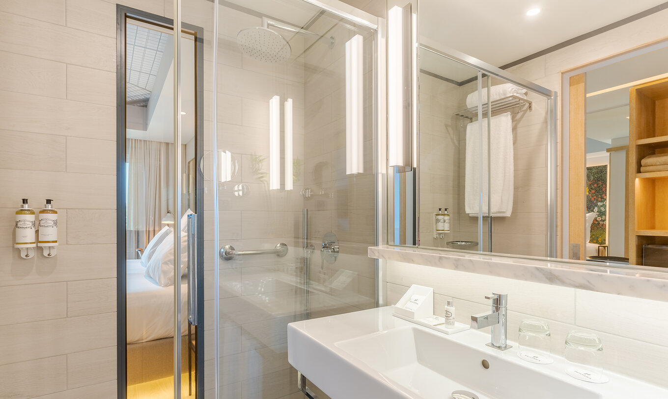 The Superior Family room at Pestana Douro Riverside features a bathroom with a sink, mirror, and shower