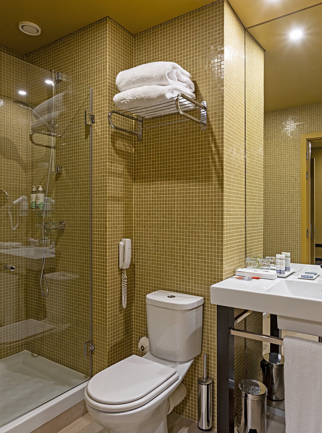 Pestana Palácio do Freixo’s Classic Attic has a bathroom with yellow tiles, toilet, and washbasin