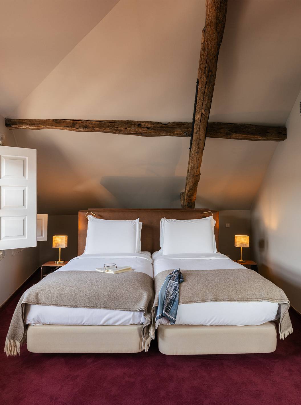 Heritage Family Suite at Pestana Vintage Porto with twin beds, bedside lamps and exposed wooden beams