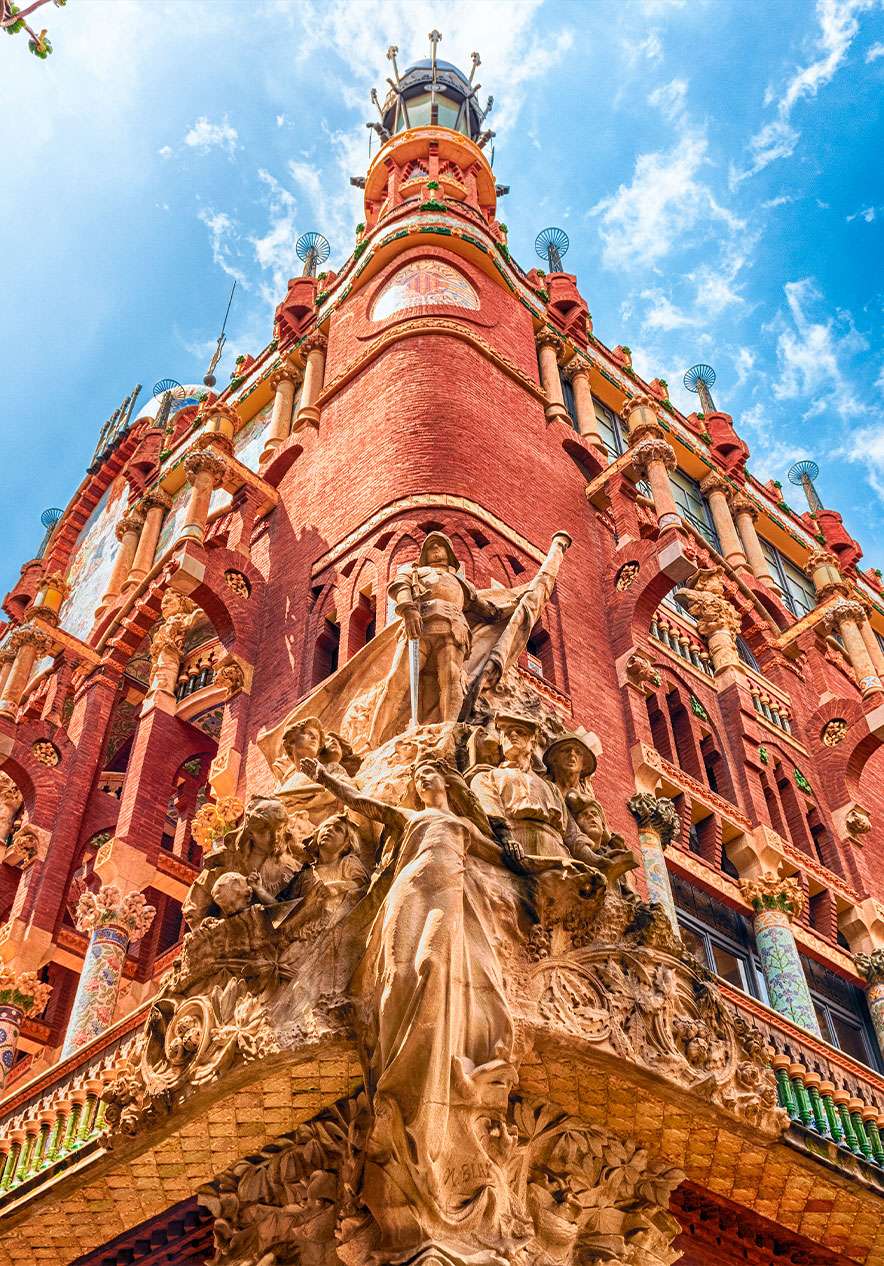 Music Palace near Pestana Arena Barcelona, Hotel em Barcelona with ornate red facade and stone sculptures