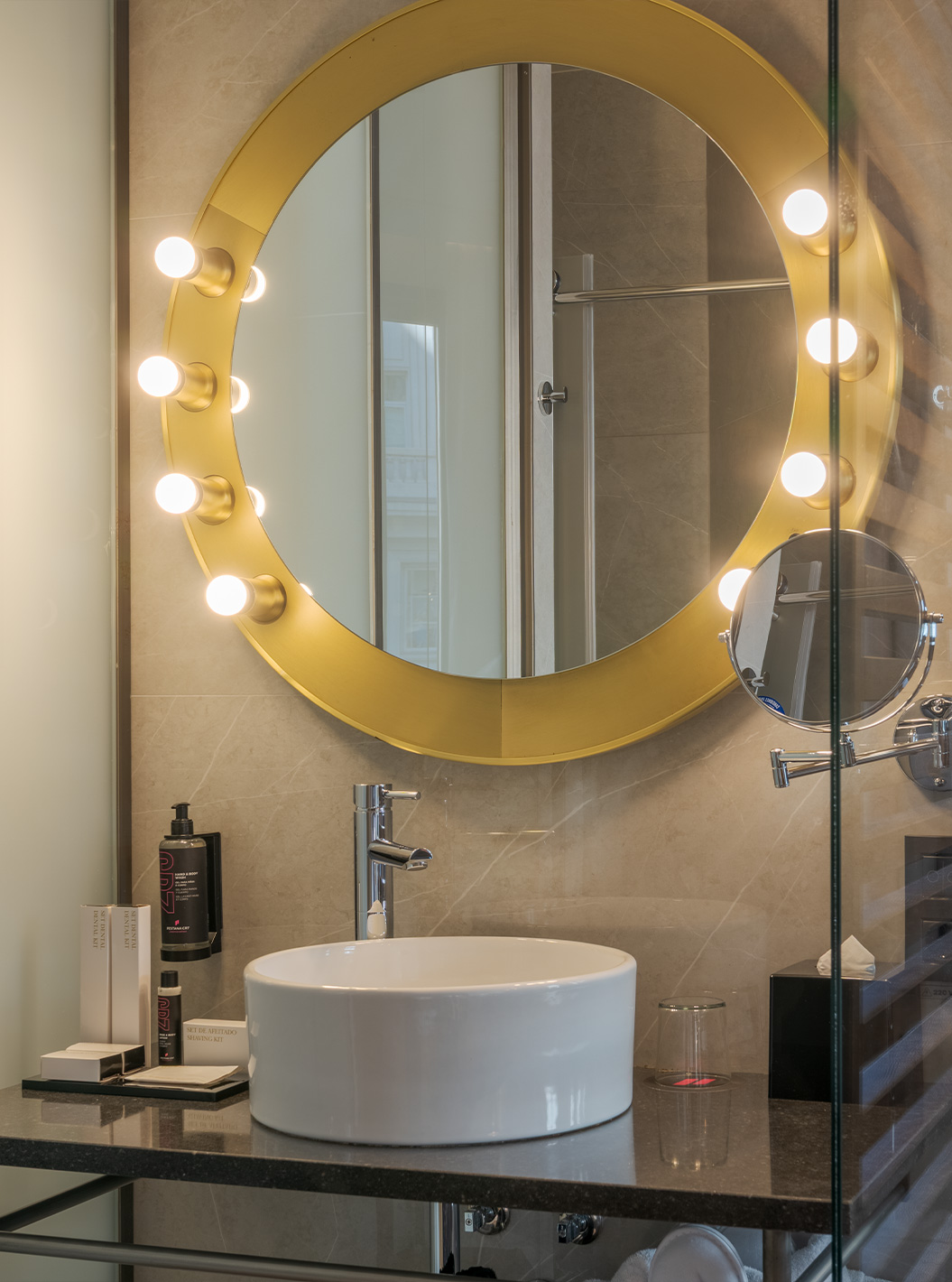 The Amazing CR7 at Pestana CR7 Gran Vía Madrid featuring a round lit mirror above a marble bathroom sink