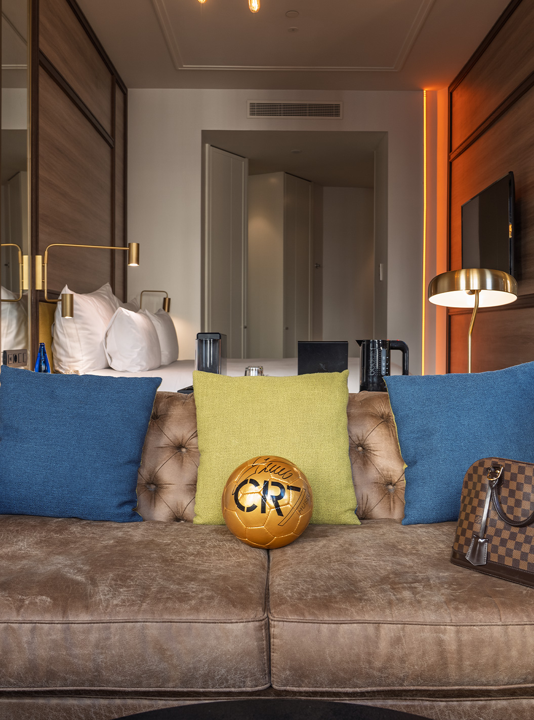 The Amazing CR7 at Pestana CR7 Gran Vía Madrid featuring a leather sofa, football and softly lit bedroom