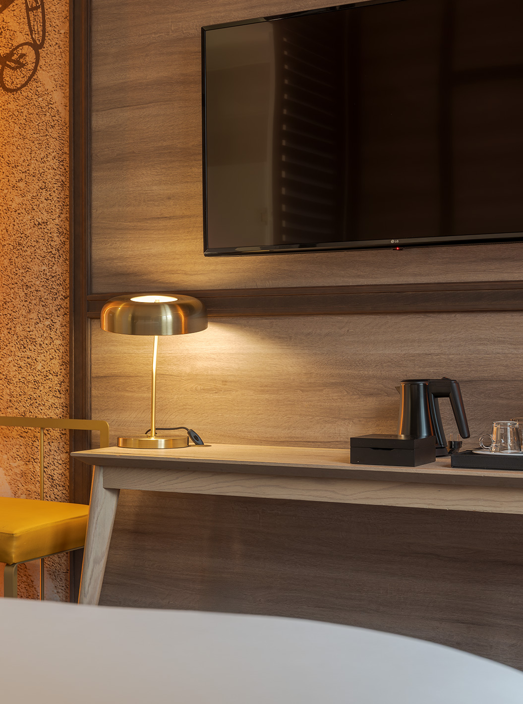 The Fantastic 7 Room at Pestana CR7 Gran Vía Madrid featuring a desk lamp, wall TV and kettle on wood desk
