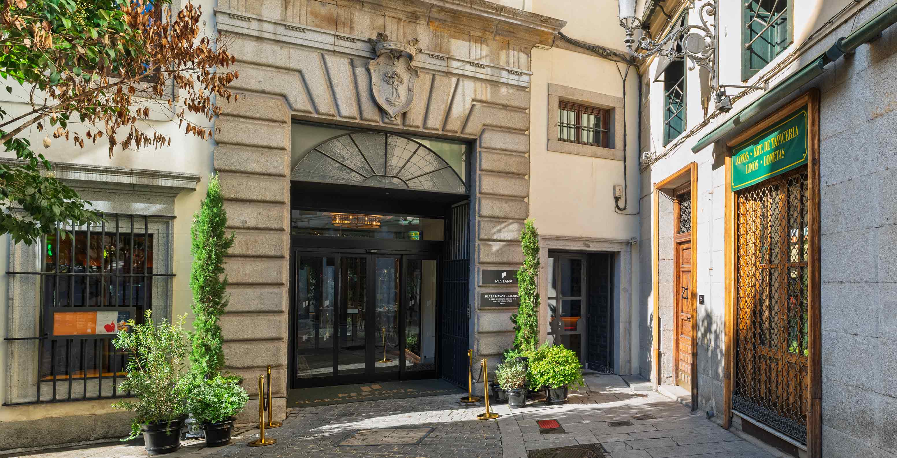 Historic stone hotel entrance near Pestana Collection Plaza Mayor, Hotel in the Historic Center of Madrid