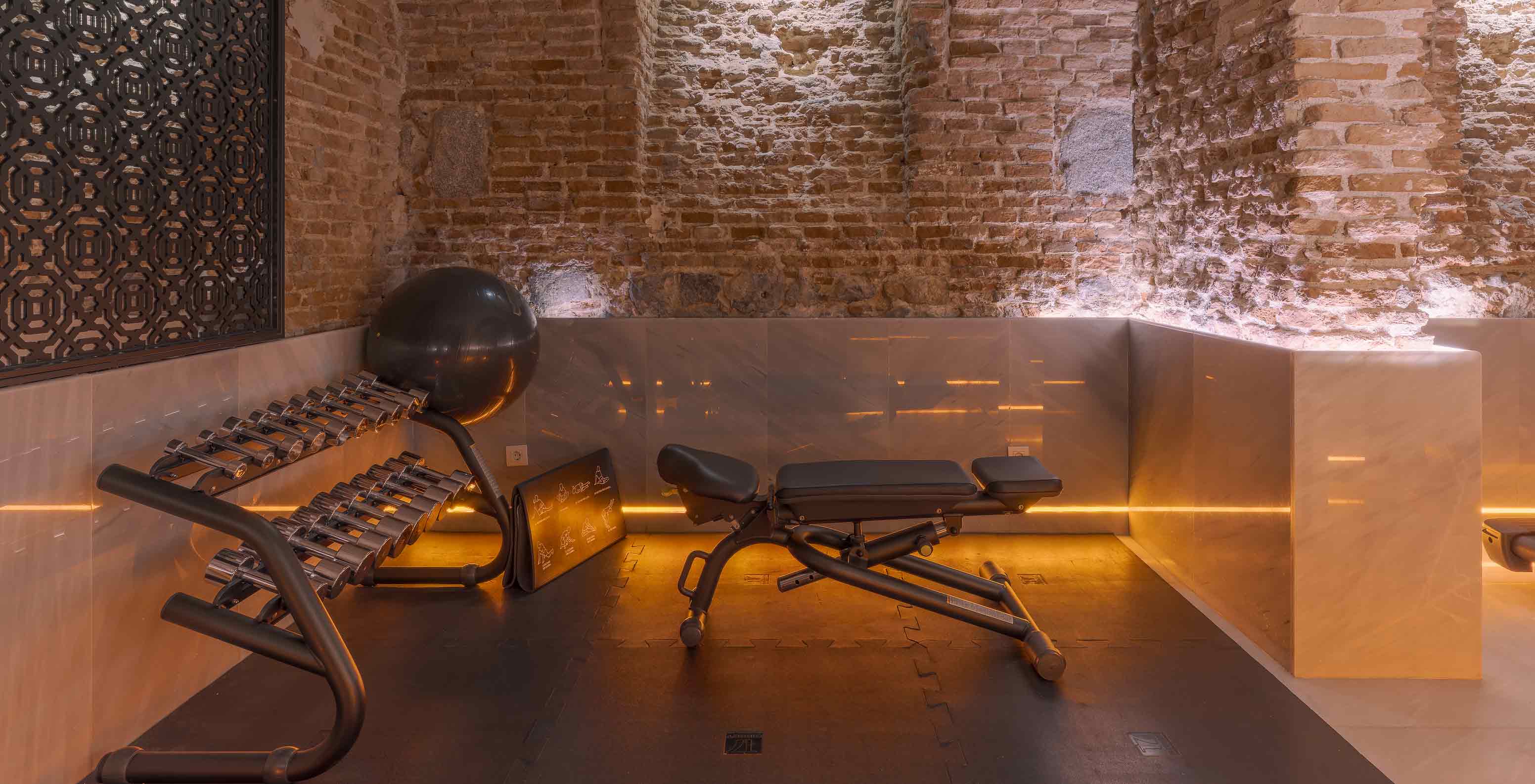 Pestana Collection Plaza Mayor Hotel in the Historic Center of Madrid featuring a compact gym with weights