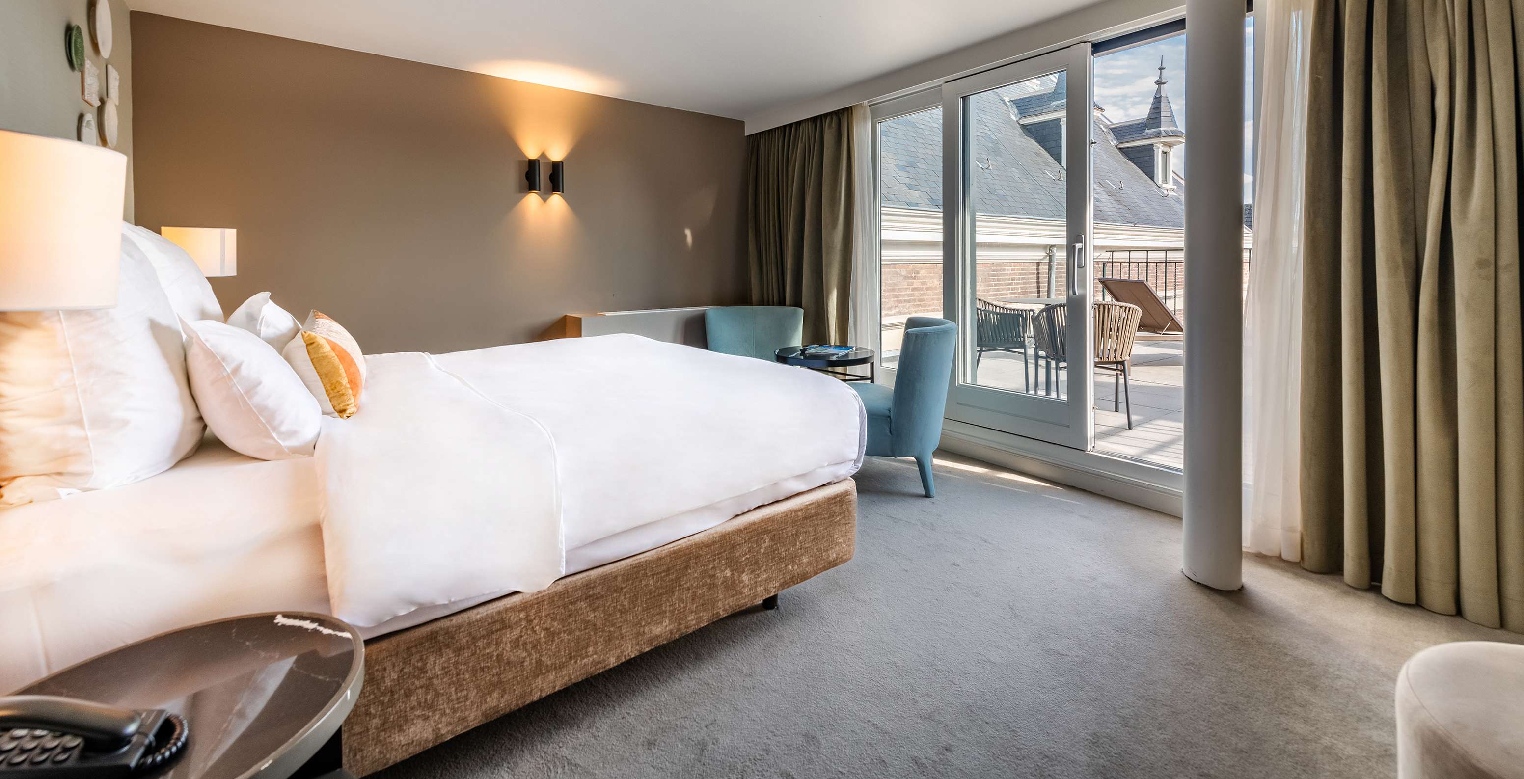 Superior Terrace room at Pestana Amsterdam Riverside has a double bed facing the balcony and two armchairs