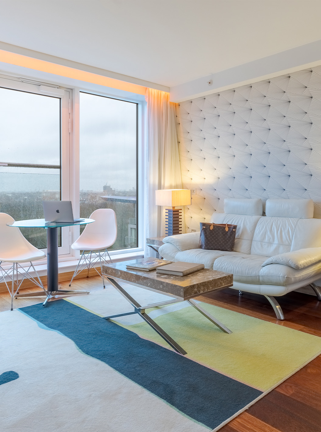 The Executive Suite with 1 Bedroom at Pestana Chelsea Bridge has a sofa with a coffee table, a table and a large window