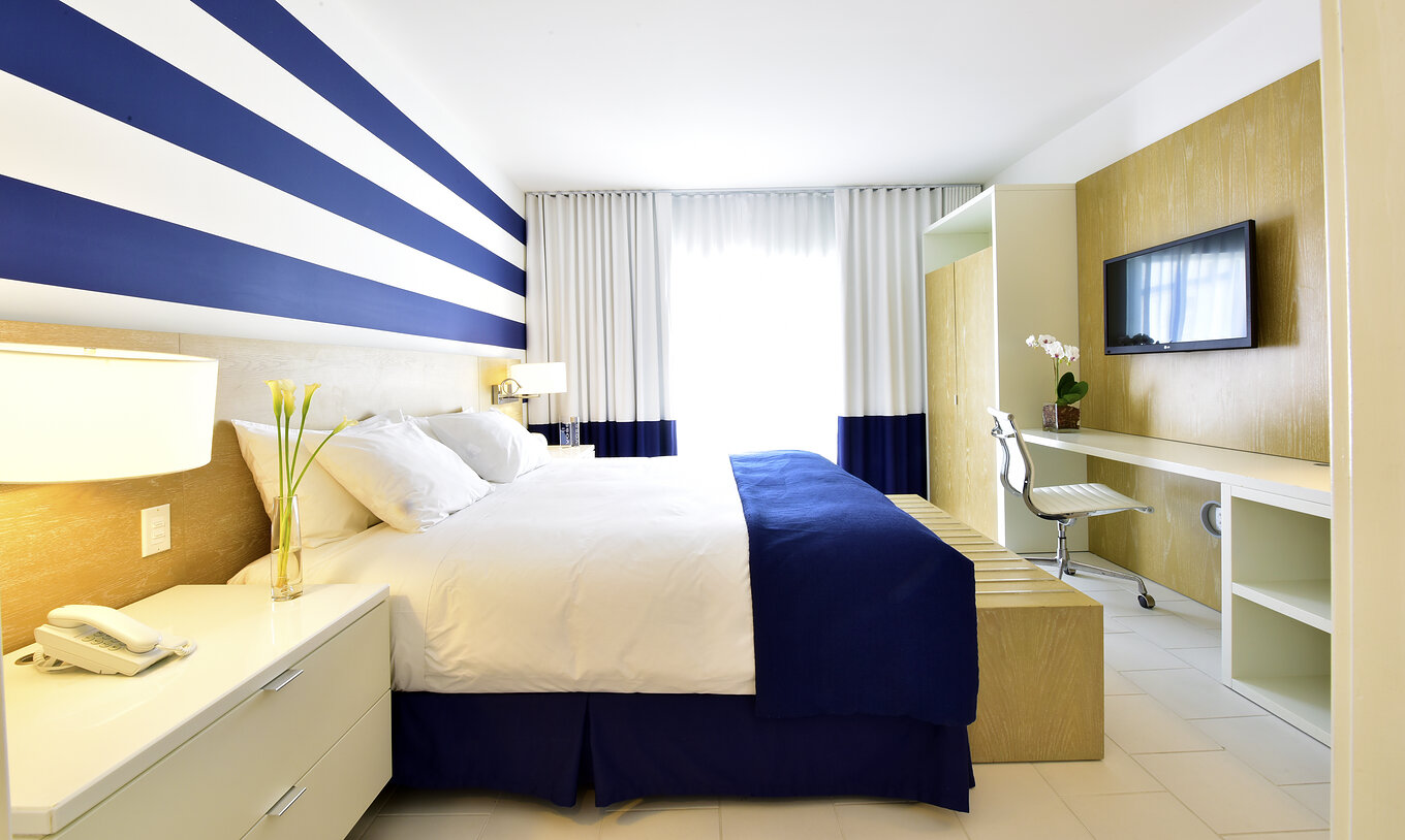 The Pestana Master Suite at Pestana Miami South Beach has a double bed, closet, TV and table