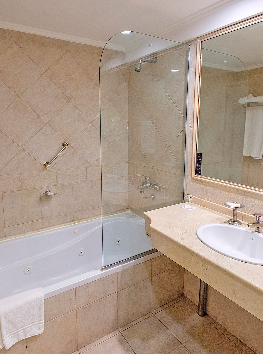 The Twin Executive Room at Pestana Buenos Aires has a bathroom with a sink, mirror, and a bathtub with a shower