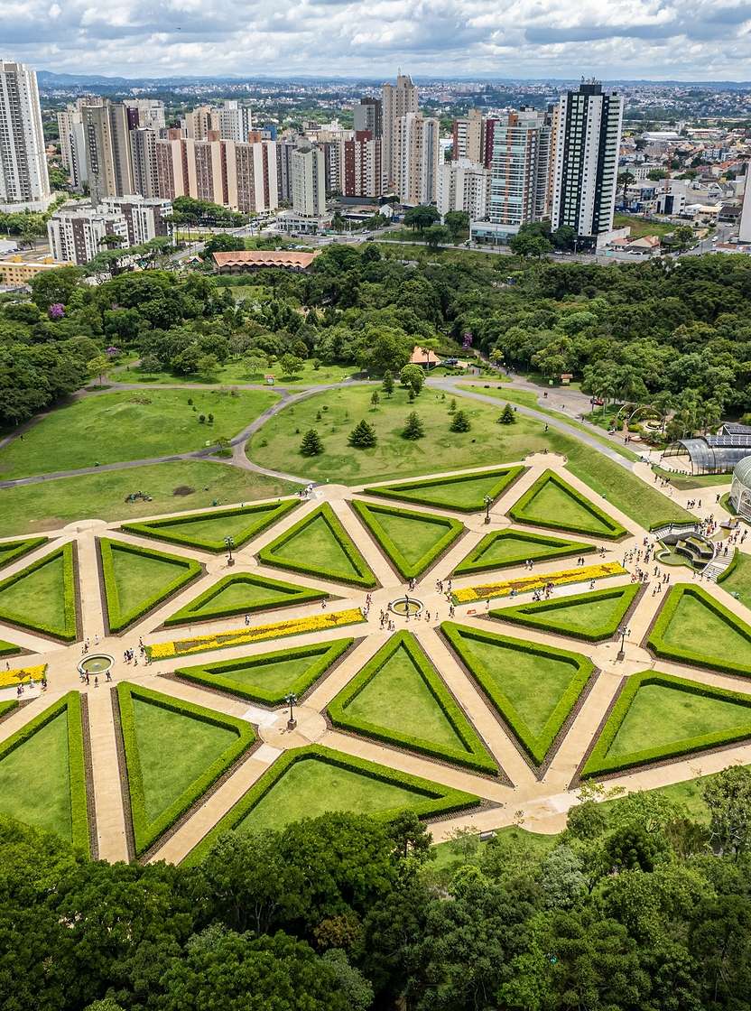 Aerial view of Curitiba with lush green parks and imposing modern architecture